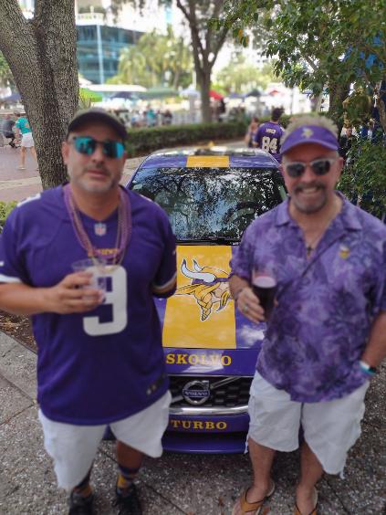President Luke Rainbow and Treasurer RC - Roger Craft with Skolvo Turbo at The Historic Downtowner holding a glass of purple beer at halftime